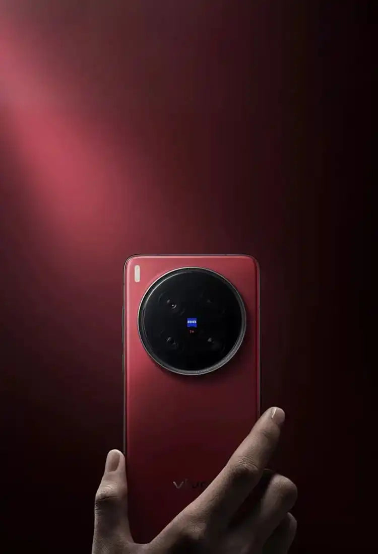 A red smartphone with a prominent circular camera module featuring a blue ZEISS logo.